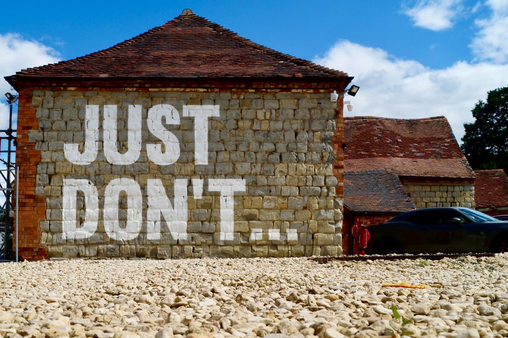 Stone house with 'Just Don't' written on one of the walls